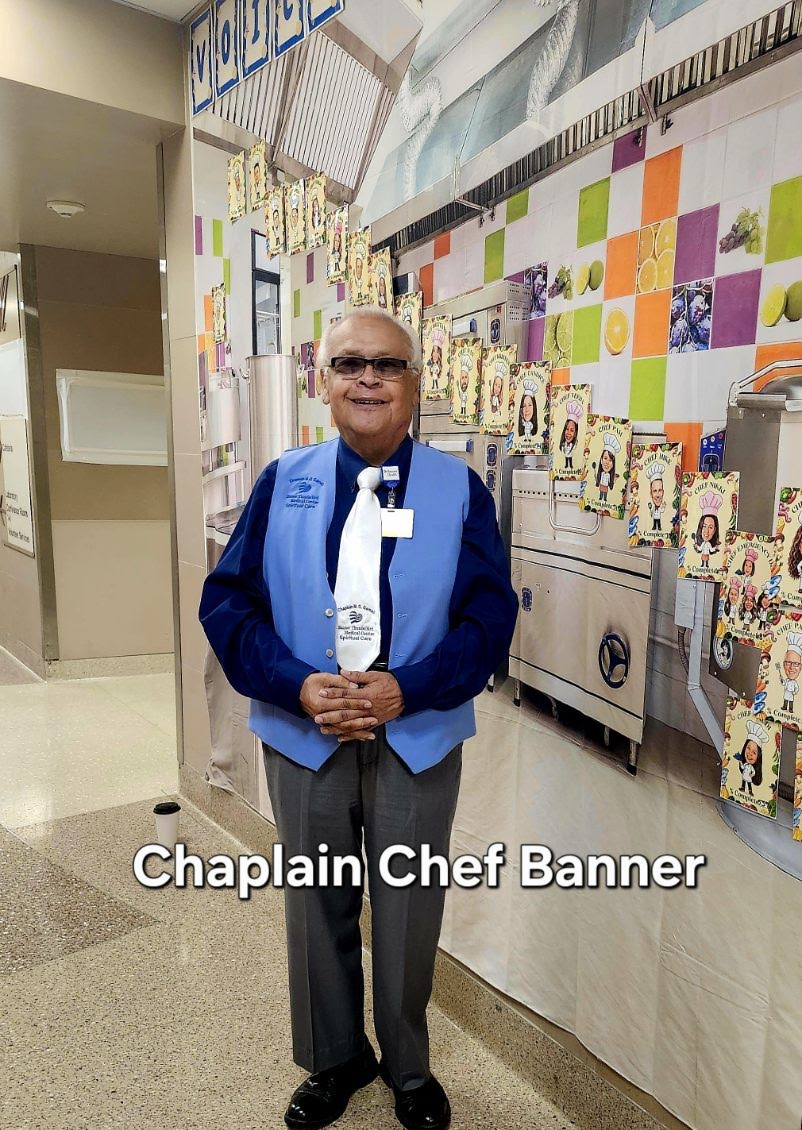 Chaplain Mannie Gomez standing beside the Chaplain Chef display at Banner Thunderbird